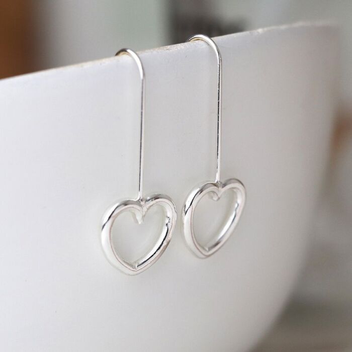 Silver plated drop heart earrings.