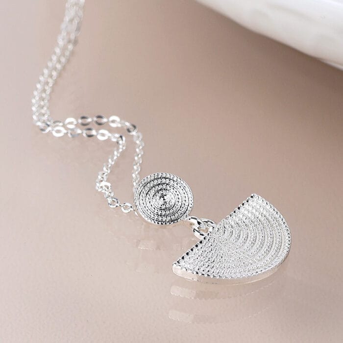 Silver plated disc and half moon necklace